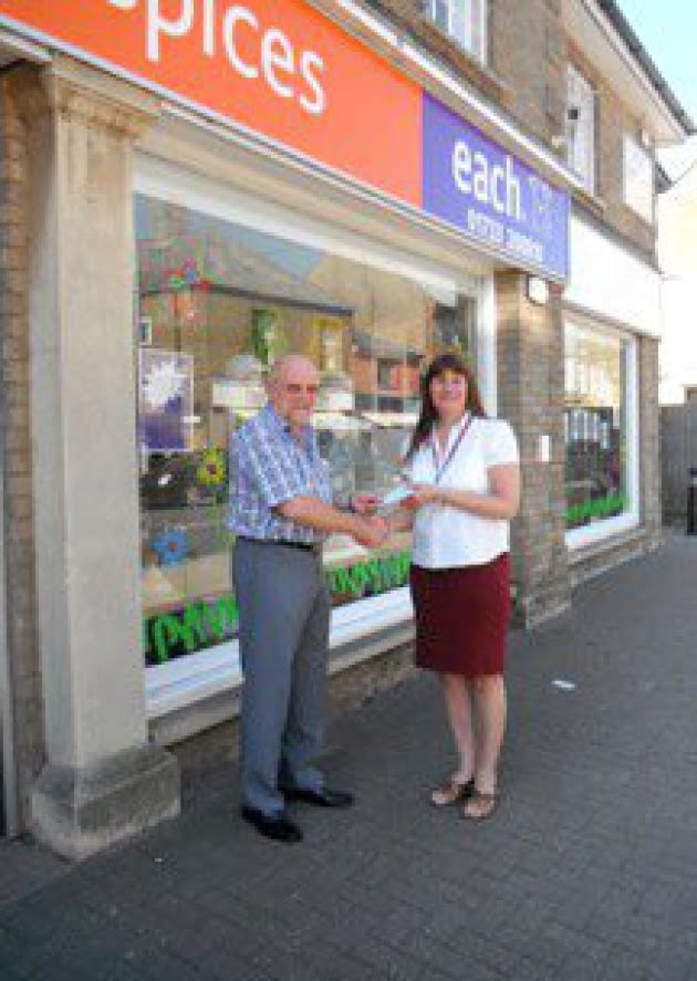 Ian Fawcett, Whittlesey Masonic Benevolent Association's worshipful master, presents a cheque to EACH relief shop manager Melanie Lamb.