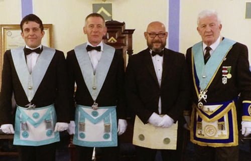 Terry Barlow (right) keeps an eye on the trio of young Masons who performed the working tools, from left to right, are: Justin Burgoyne, James Wilkes and Neil Callaghan.