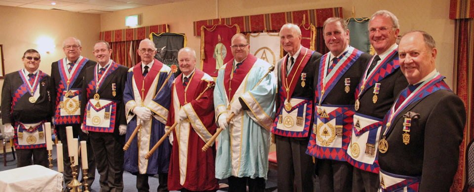 The three principals (centre) surrounded by distinguished guests.