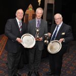 Roger Waltham and Roger Odd helping Peter Rodd with his trophies