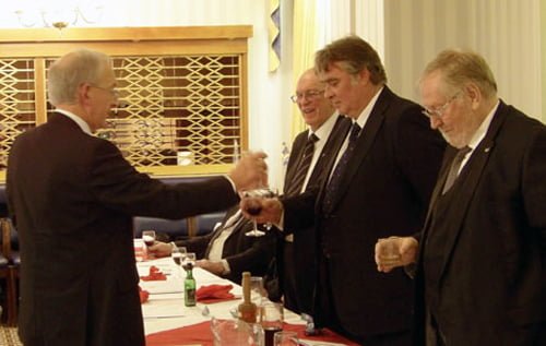 David Harrison (left) toasts the three principals during his rendition of the traditional song to their health.