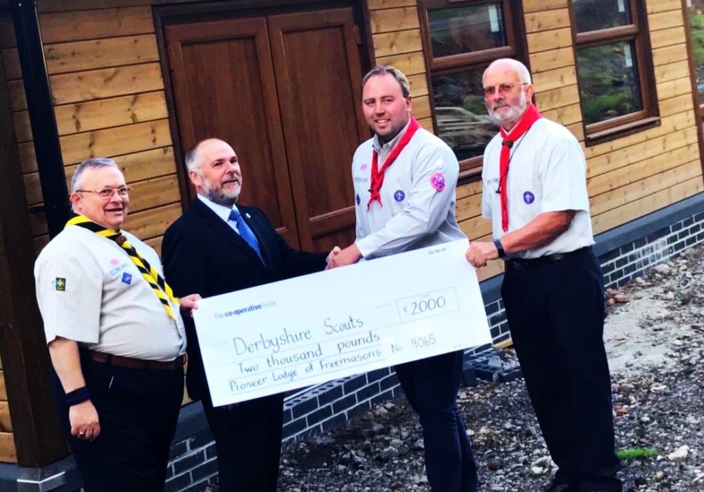 Photo of Master of Pioneer Lodge, W Bro. Andy Brown, accompanied by the Charity Steward, W Bro. Don Newing, and W Bro. Tony Harvey, presented the County Commissioner for Derbyshire, James Stafford, accompanied by the centre’s project manager, Tom Stoddart, with the cheque for £2,000.