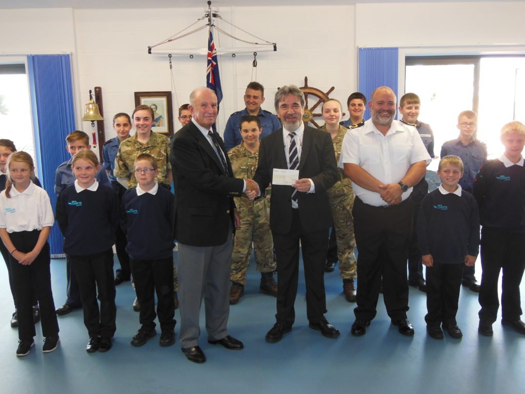 Picture of W. Bro. Dr. Reuben Ayres, Devonshire Freemasons Provincial Charity Steward, presented Tony Griffin, the Chairman of the Exmouth Sea Cadets Management Committee