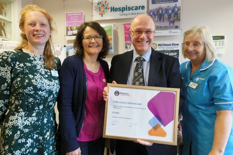 Photo of This year as part of their annual support of hospices throughout the country the Assistant Provincial Grand Master of Devonshire W. Bro. Craig Cox can be seen presenting a certificate denoting the £1000 given on behalf of the Devonshire Freemasons and the Masonic Charitable Foundation to Carey MacKenzie, Chris Webber and Julie Morris at Hospiscare’s Pine Lodge Day Hospice in Tiverton (Image: Devonshire Freemasons)